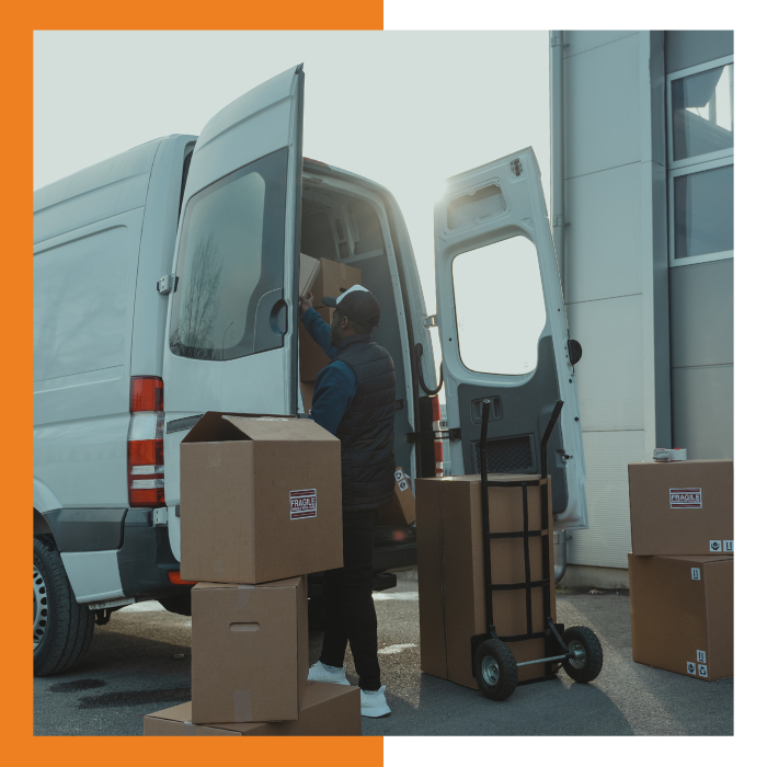 Delivery man unloading boxes from delivery truck