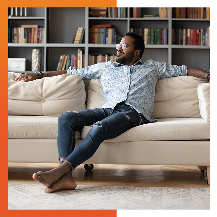 Man relaxing on the couch in his home