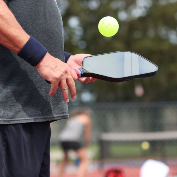 man with pickleball paddle