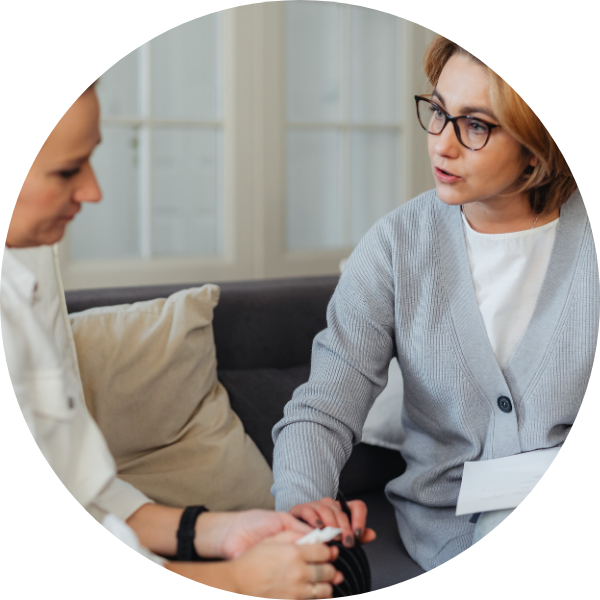 couselor holding woman's hand in support