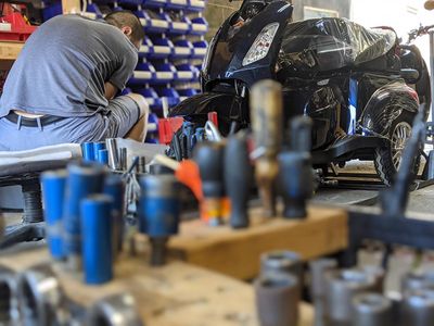 Image of a man working on a bike