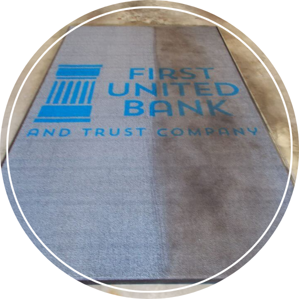 A carpet that reads "First United Bank And Trust Company" that has only been half cleaned