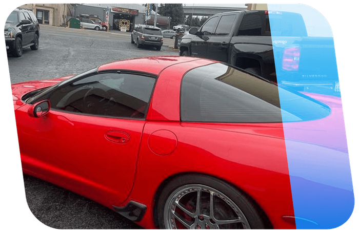 a red Corvette with dark window tinting