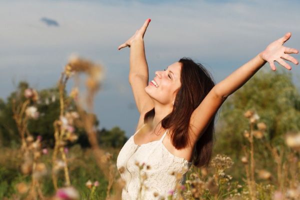 a woman looking joyful in a field of flowers Become A Surrogate (2).jpg