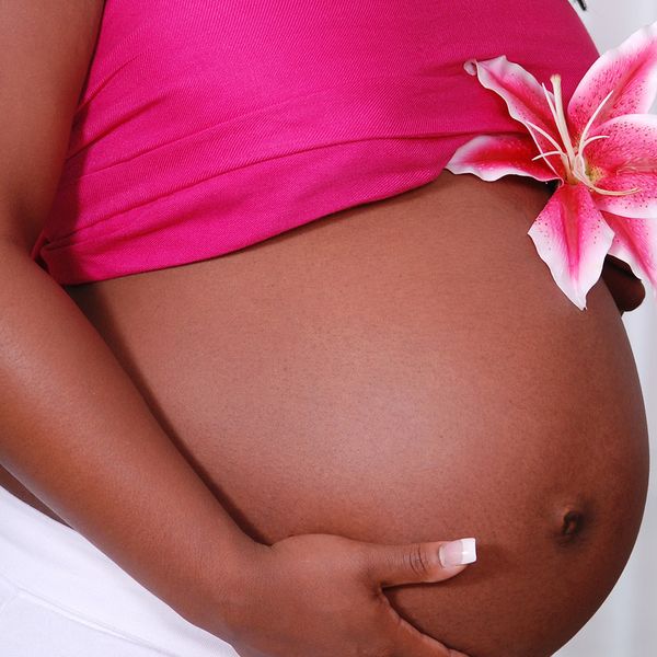 Close-up of pregnant woman with flower