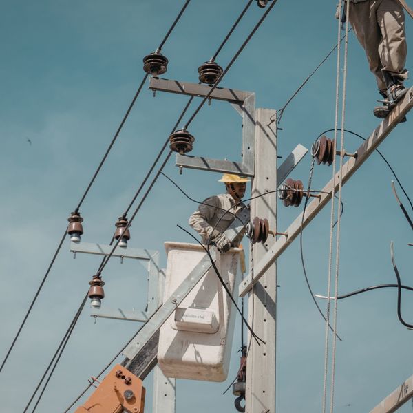 Utility worker in a bucket truck repairing power lines.