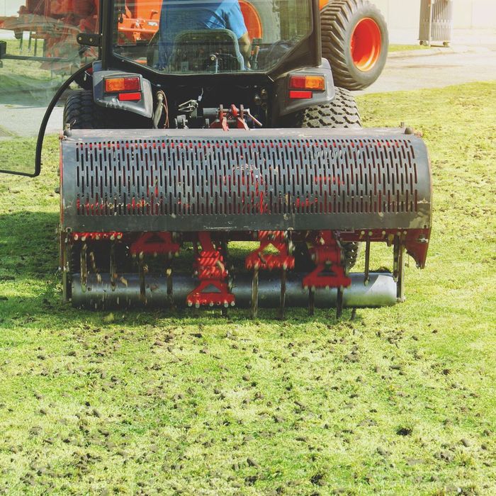 an aeration machine poking holes in the grass