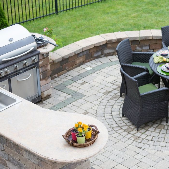 An outdoor kitchen with a table