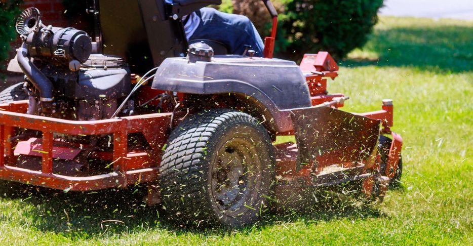 a riding lawn mower cutting grass