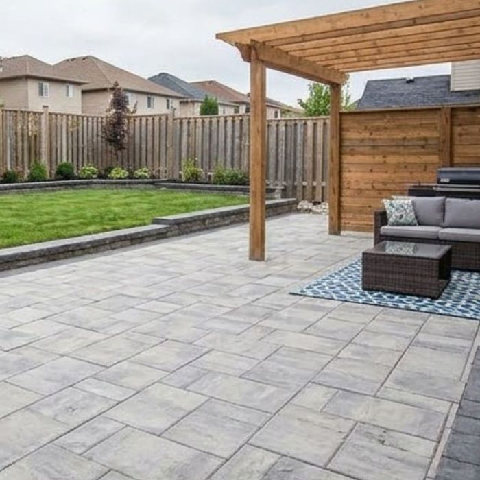 A backyard patio that is stone paved