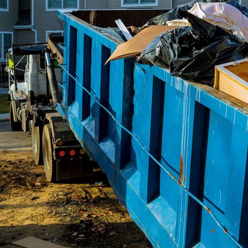 hauling away blue dumpster