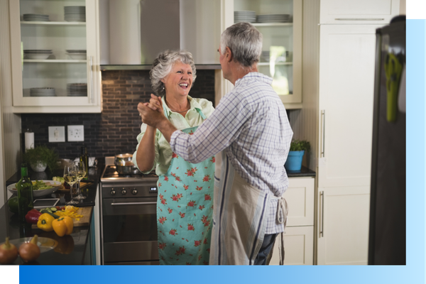 A couple dancing in their ktichen.