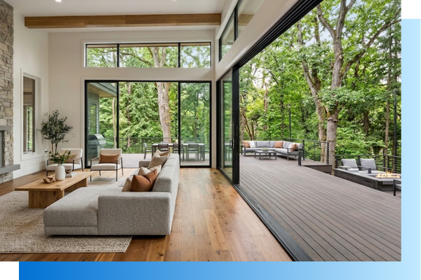 modern living room featuring massive sliding glass doors that open seamlessly onto a high-end composite deck