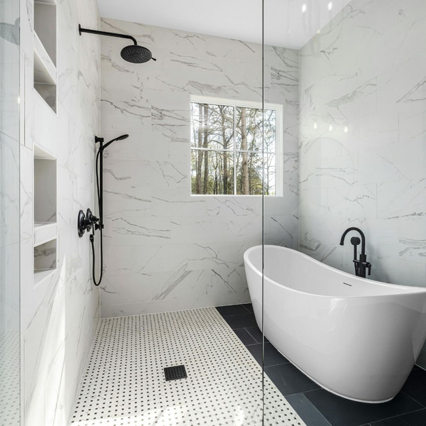 tub in large shower room, marble walls