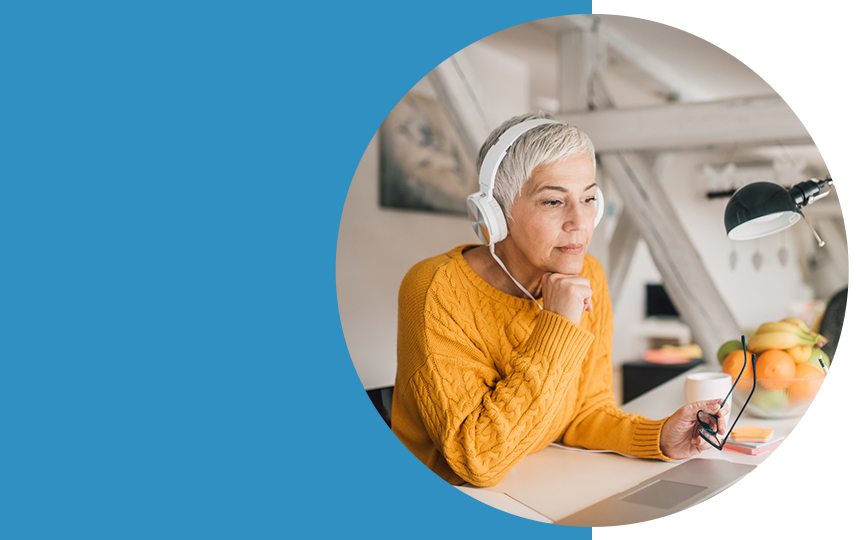 A woman wearing headphones transcribing a recording