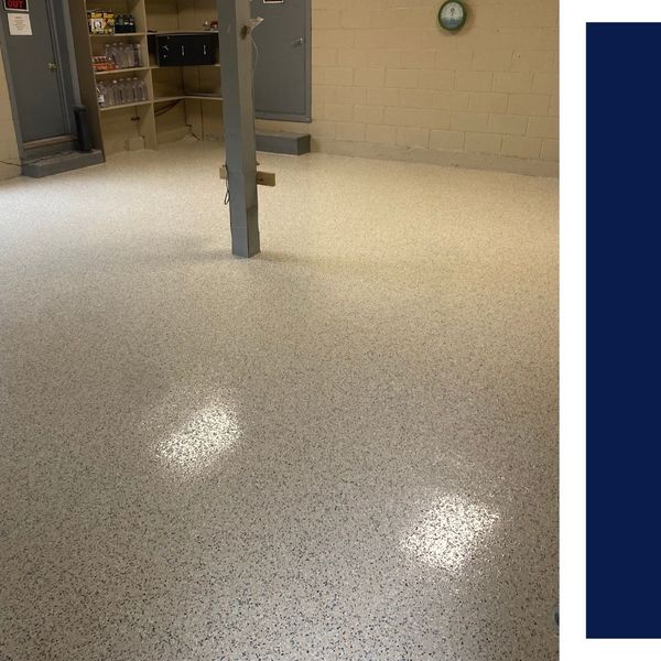 Large-scale commercial epoxy floor installation in a neutral tan flake finish with high-gloss topcoat.