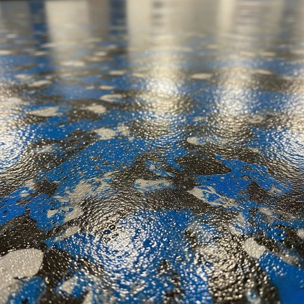 A detailed close-up of a durable and textured polyaspartic floor coating.