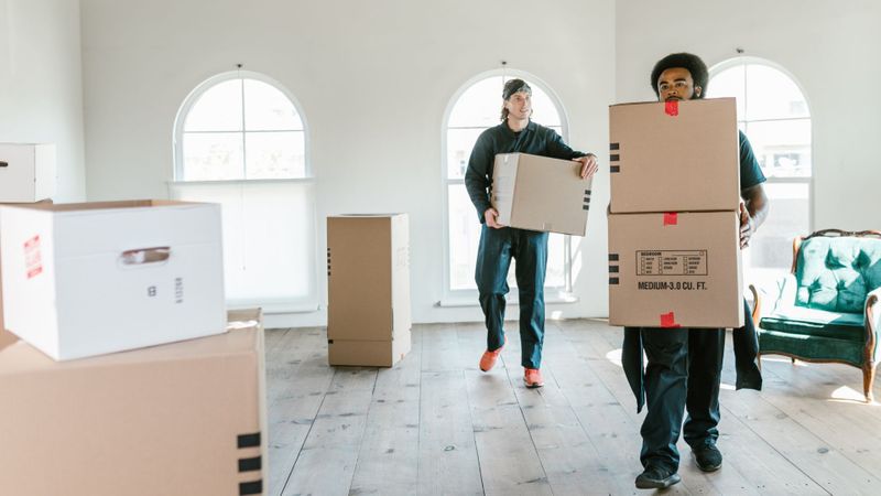 The professional team from Kane and Family Movers carefully loading furniture into a moving truck.