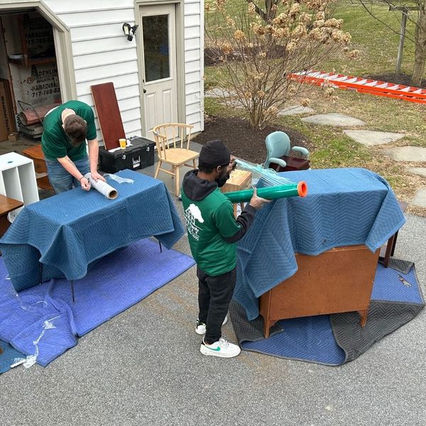 movers carefully wrapping up furniture