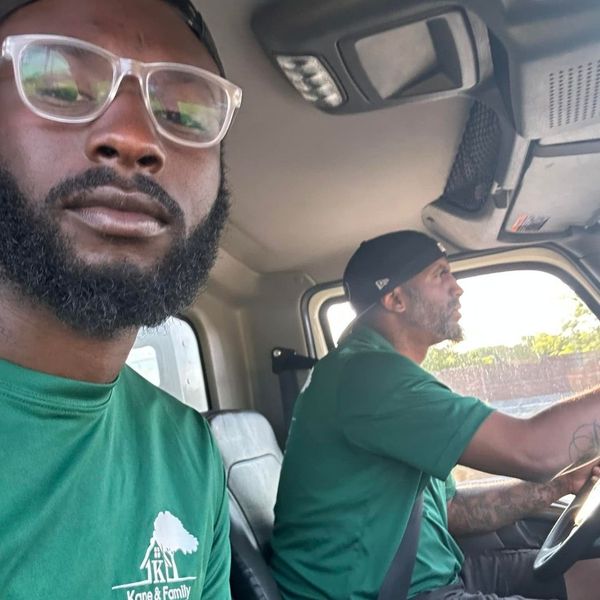 Two movers sitting in the cab of a moving truck. Two movers sitting in the cab of a moving truck.