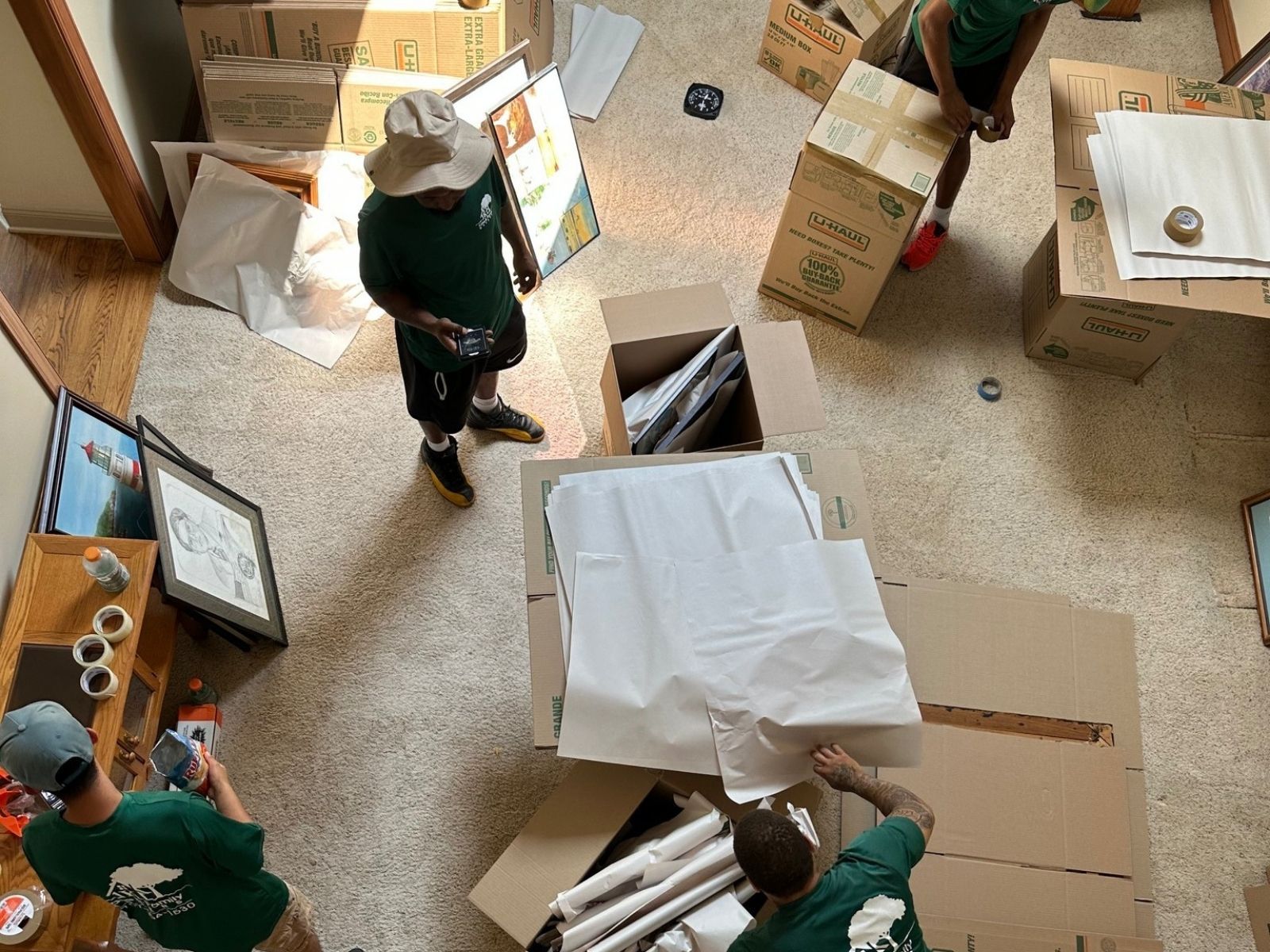 movers carefully packing artwork into boxes 