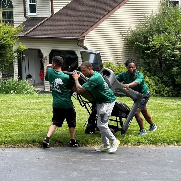 The Kane and Family Movers team moving an exercise machine.