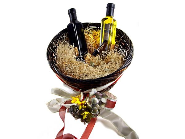 Decorated gift basket with bottles of olive oil and vinaigrette