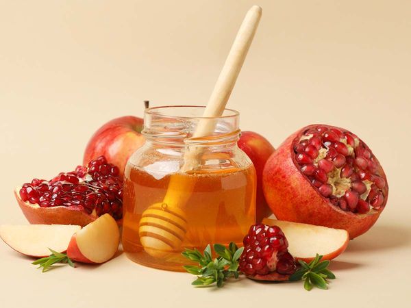 Apple, honey and pomegranate on beige background Apple, honey and pomegranate on beige background