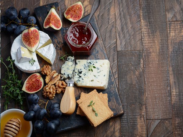 A gorgeous charcuterie spread of cheese, nuts, figs, jam and crackers using a Pompo’s Boards charcuterie board. Pompo’s Boards charcuterie board