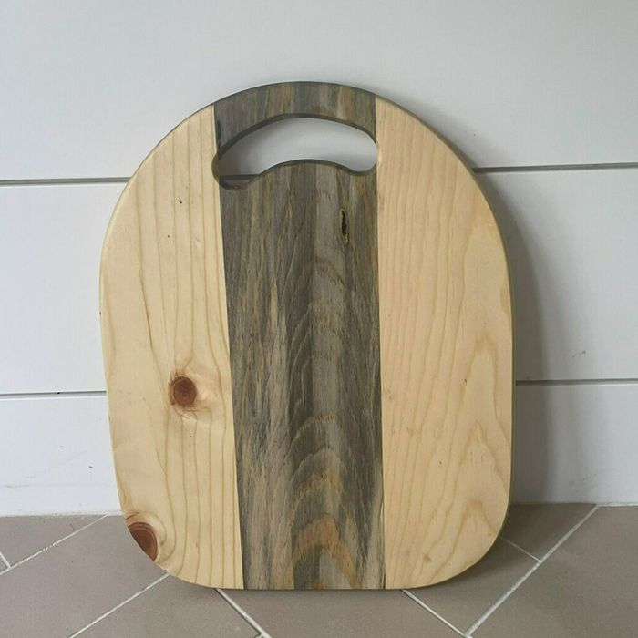 A round charcuterie board made of natural wood.