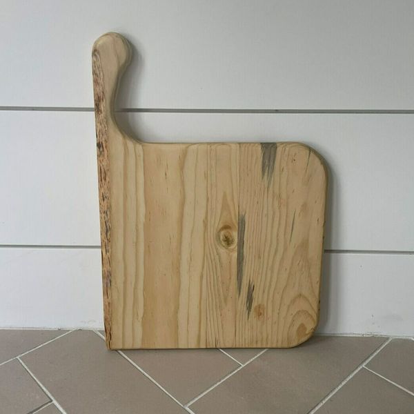 A custom-made square charcuterie board with a handle.
