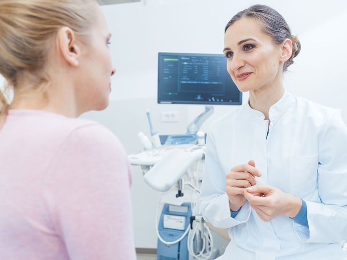 Woman talking to doctor.