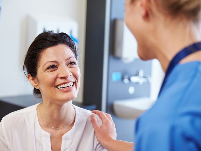 Woman talking to doctors.