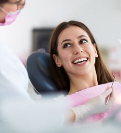 Young woman smiling in dentist chair