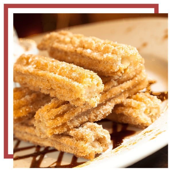  An image of a plate of churros with ice cream and chocolate sauce