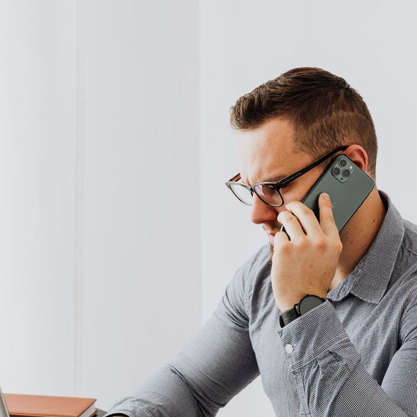 Man on the phone scheduling a mobile auto repair