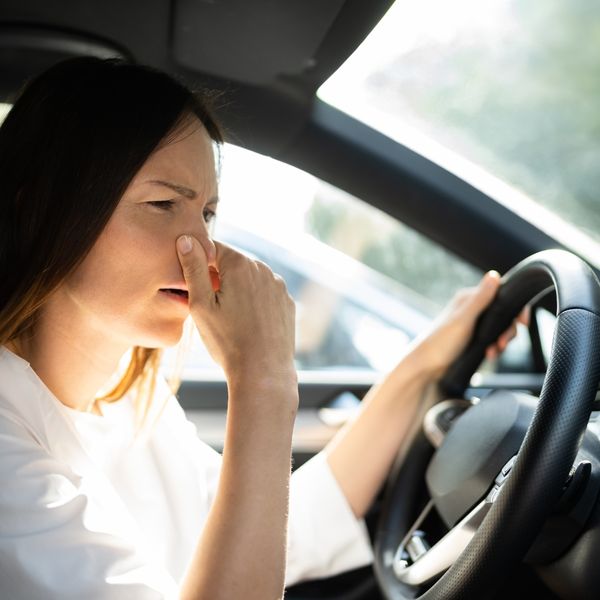 woman smelling a bad alternator