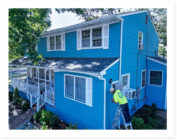 LVS team painting a blue house