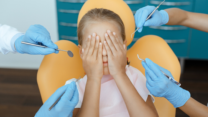 Young girl anxious at dentist