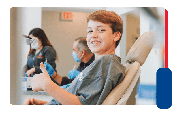 smiling teenager in dental chair