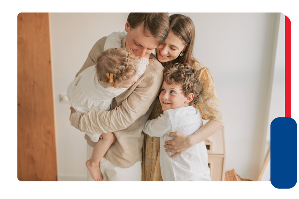 A family smiling and hugging