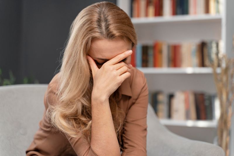 blonde-woman-covering-face-with-hand.jpg