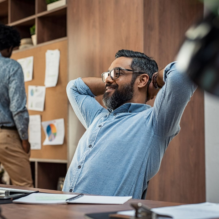 man stretching at his desk