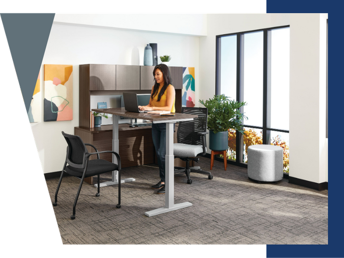 woman standing at office desk woman standing at office desk
