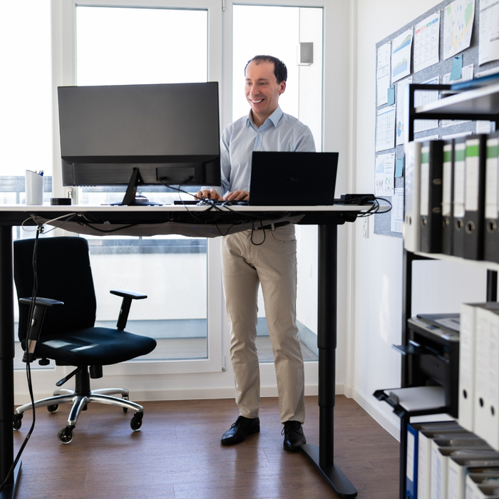 man standing at standing desk