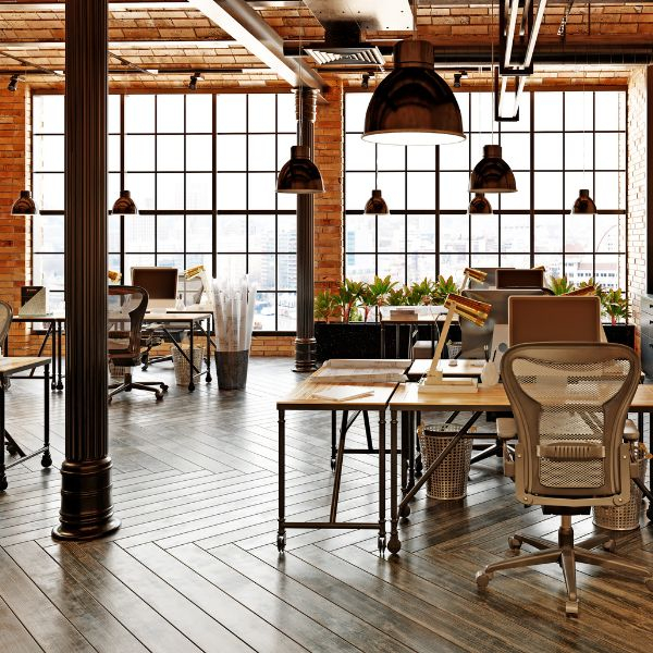 An office with open windows and wood floors