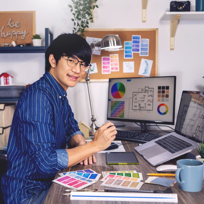 A graphic designer works in his home office