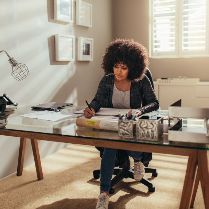 A woman sits at her desk in a home office