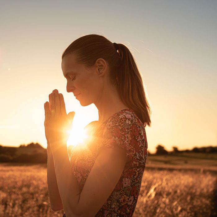 Woman in field praying