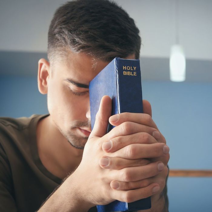 a man praying with a bible